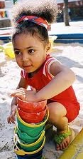 toddler girl in sandbox